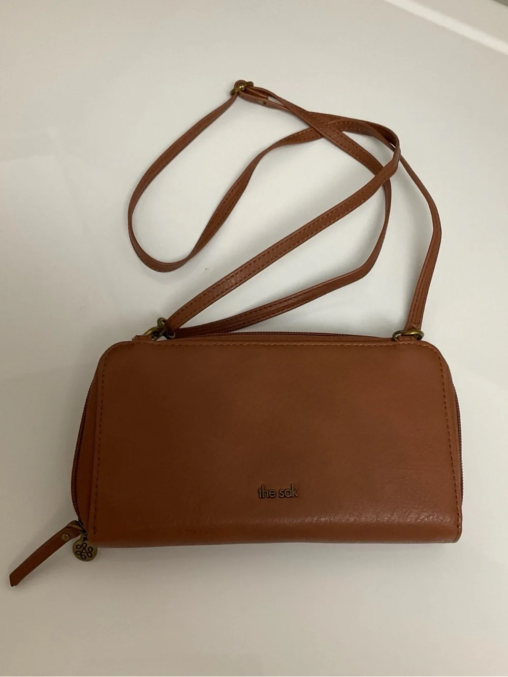 The Sak Tan Crocheted Crossbody Wallet with Adjustable Strap and charm